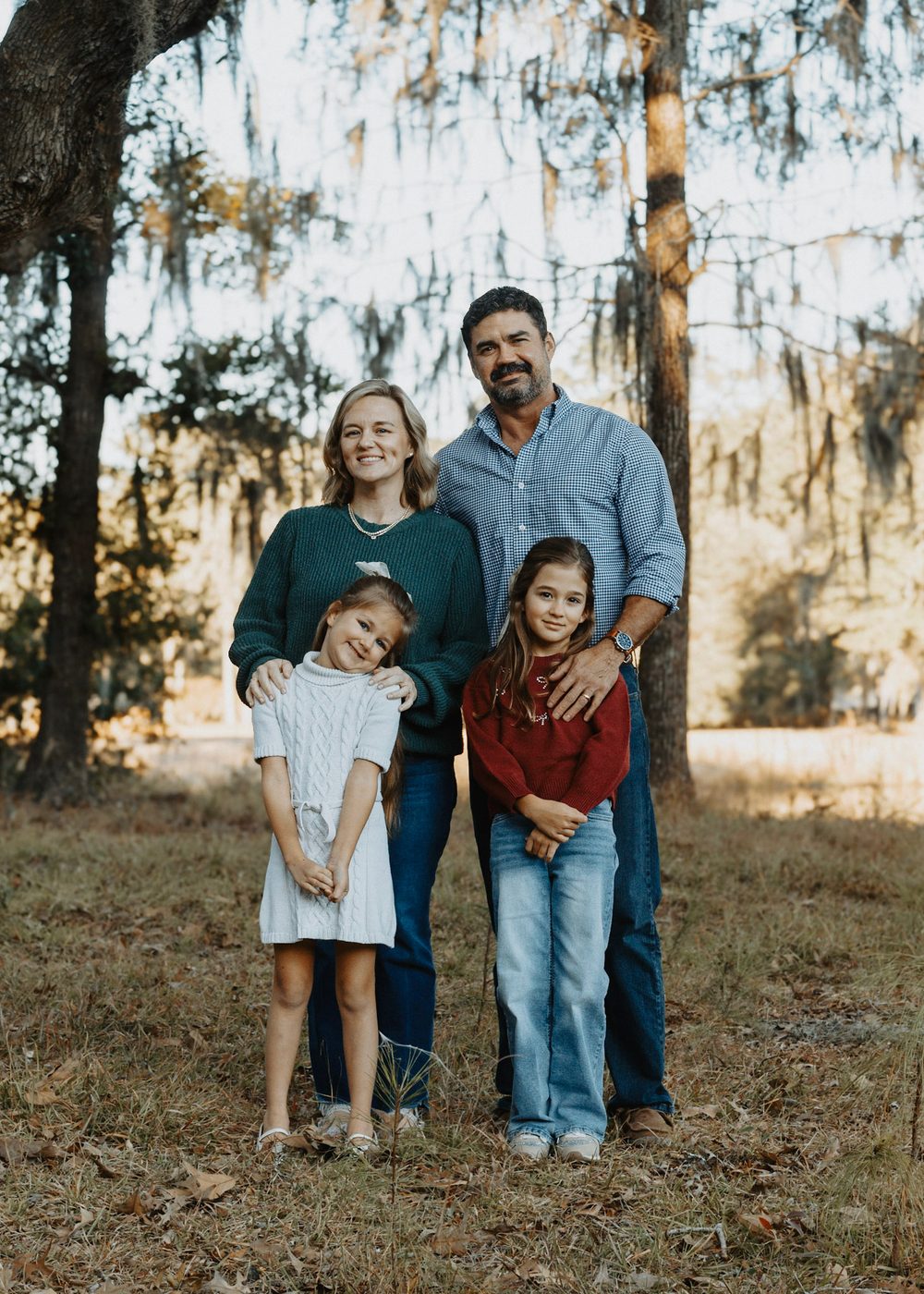 Rob and Kristen Marshall with their two daughters under live oaks draped in Spanish moss